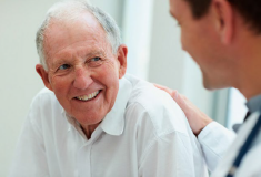 Older man with younger man who has his hand on his shoulder.png